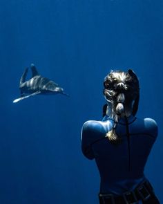 a woman is taking a photo of a shark in the water