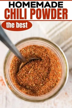 the best chili powder in a glass jar with a spoon on top and text overlay