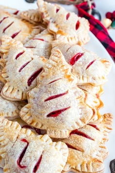 a white plate topped with mini pies covered in icing next to christmas decorations