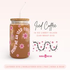 a glass jar with a straw in it and flowers on the lid, next to a sticker that says iced coffee