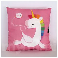 a pink pillow with a white unicorn on it