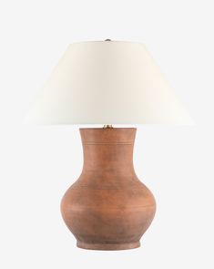 a wooden lamp with a white shade on it's base and a light bulb in the middle