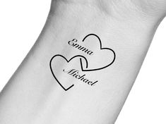 two hearts tattoo on the left side of someone's arm that says, sunnya michael