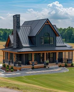 a large house with a metal roof in the middle of a field