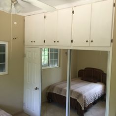 a bedroom with mirrored closet doors and a bed