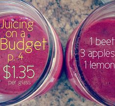 two jars filled with juice sitting on top of a counter