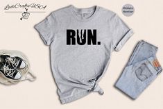 a shirt that says run on it next to jeans and sneakers