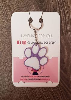 a key chain with a dog's paw on it