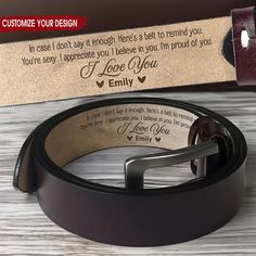 a leather belt with the message i love you on it next to an empty box