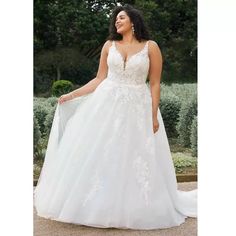 a woman in a wedding dress standing outside