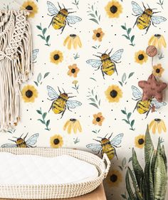 the wallpaper has sunflowers and bees on it, along with a white crib