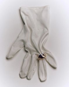 a pair of white gloves sitting on top of a table