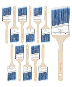 six blue paint brushes with white bristles and wooden handles, all lined up against each other