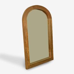 an arched wooden mirror on a white background