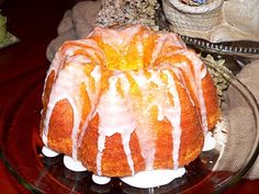 a bundt cake sitting on top of a glass plate next to a stuffed animal