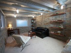 a living room filled with furniture and a flat screen tv mounted to the wall next to a window