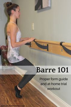 a woman is doing an exercise on the wall with a wooden bar in front of her