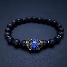 Not only does the Luxury Antique Crown with Lava Stone and Lapis Lazuli Bracelet look great and make the perfect gift for someone. Lava Stones are wonderful for calming the emotions and is the only rock to come from nothing but fire and thus providing strength and power. It can teach you to ignite the fire within you and allow your true expression to show. Lapis Lazuli brings out your inner priestess, heightens inner-vison and deepens wisdom. It benefits from the Root Chakra which helps you feel Man Jewellery, Stone Bead Bracelets, Antique Crown, Lion Head Bracelet, Blue Tiger Eye Stone, Fancy Stuff, Men Bracelets, Beads Work, Lava Stone Bracelet