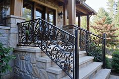 a wrought iron stair railing on a stone house