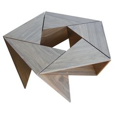 an unusual wooden table with two intersecting pieces on it's sides and one in the middle