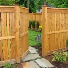 two wooden gates are open in a garden