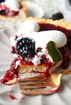 a piece of pie with berries and whipped cream on top