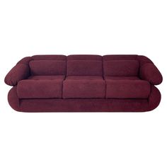 a red couch sitting on top of a white floor