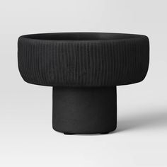 a black vase sitting on top of a table