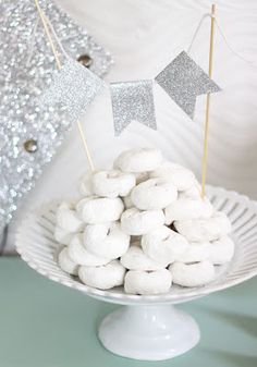 a white plate topped with marshmallows on top of a table