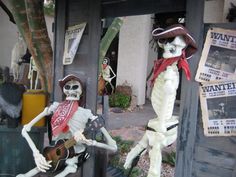 two skeletons dressed up as pirates playing guitars