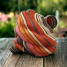 a colorful hat sitting on top of a wooden table