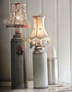 two tin can lamps sitting next to each other