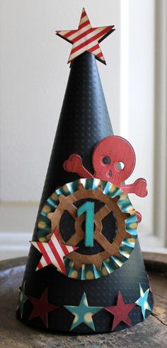 a black party hat with red, white and blue decorations on the top that says 1 o'clock