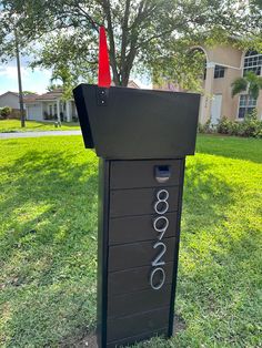 a mailbox sitting in the grass next to a tree