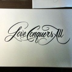 some type of calligraphy that is on the side of a white paper with black ink