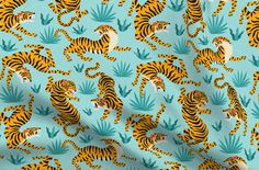 a blue and yellow tiger pattern with green leaves