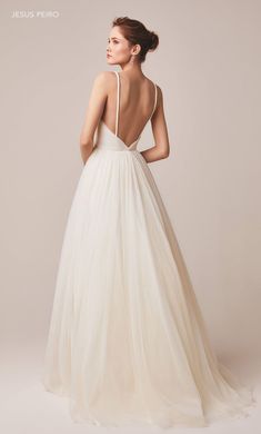 a woman in a white wedding dress looking back