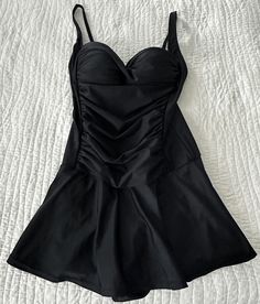 Venus St. Tropez Swim Dress Black Size 8 This elegant swim dress is ready for its moment in the sun, and it's deserving considering how unbelievably flattering it is. Its little secret: a control lining that offers mid-level shaping support. With a sweetheart neckline, ruched middle and feminine skirt that provides flirty coverage, this one-piece will easily become your new fave. Control lining Adjustable straps Molded cups Full coverage skirt Domestic or import of quality nylon/spandex tricot Only worn a few times, in lovely condition with no tears or pulls. From a smoke free home and washed in delicate detergent and ready to wear :) This item is still for sale on the Venus web site for $59.90 with out tax or shipping costs. I love it but it a little to tight in the top for me. I do have Black Lined One-piece Swim Dress, Fitted Black Swim Dress With V-neck, Stretch V-neck Swim Dress, Black Stretch Swim Dress With Built-in Bra, Sleeveless Black Swim Dress With Built-in Bra, Feminine Skirt, Swim Dress, Women Swimsuits, Festival Season