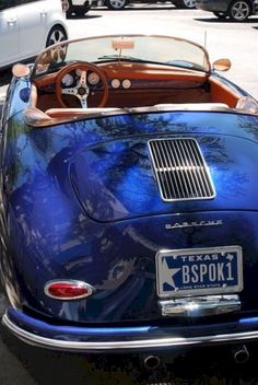 a blue sports car parked on the side of the road