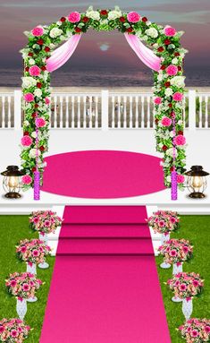 an outdoor ceremony setup with pink and white flowers on the aisle, decorated with greenery