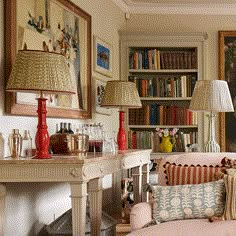 a living room filled with furniture and lots of books