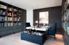 a living room filled with furniture and bookshelves