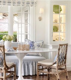 a white dining room with blue and white decor