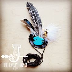 a feather quill with a blue bird on it sitting on top of a table