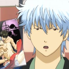 an anime character with blue hair is holding up a book in front of his face