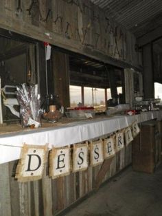 there is a sign that says dessert hanging from the wall in front of a window