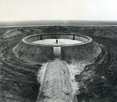 a man standing in the middle of an open pit