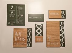 some wooden signs on a white wall with black and white lettering that says mechanical restroom