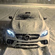 a car is covered in snow on the road