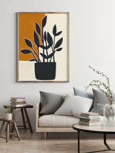 a living room with a couch, coffee table and potted plant on the wall